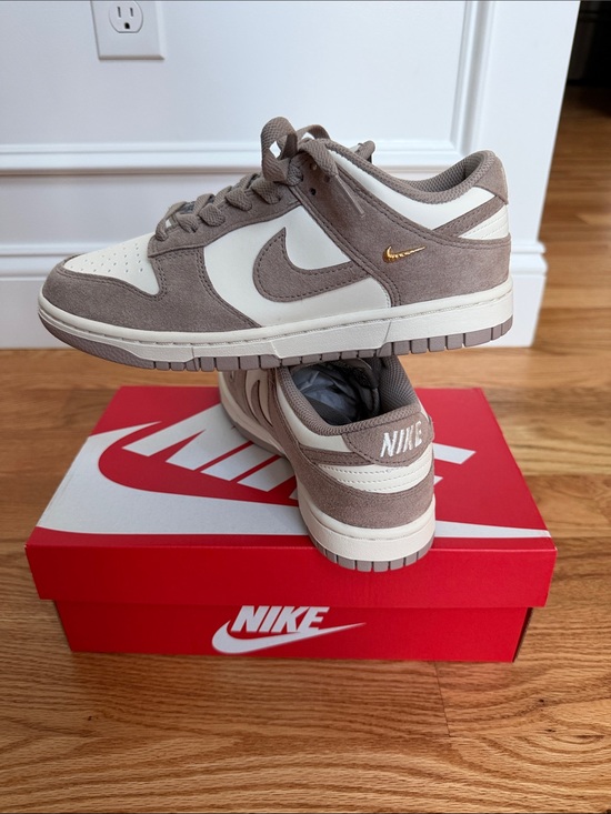 Nike Shoes - Nike Women’s Dunk Low-Top Sneakers in Taupe and White with Gold Swoosh